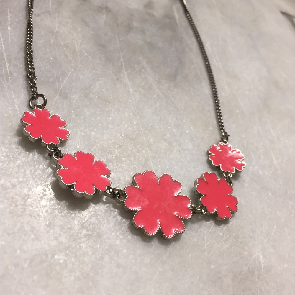a pink necklace with flowers